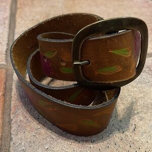 Ginuwine, leather tooled and painted belt with a brass buckle